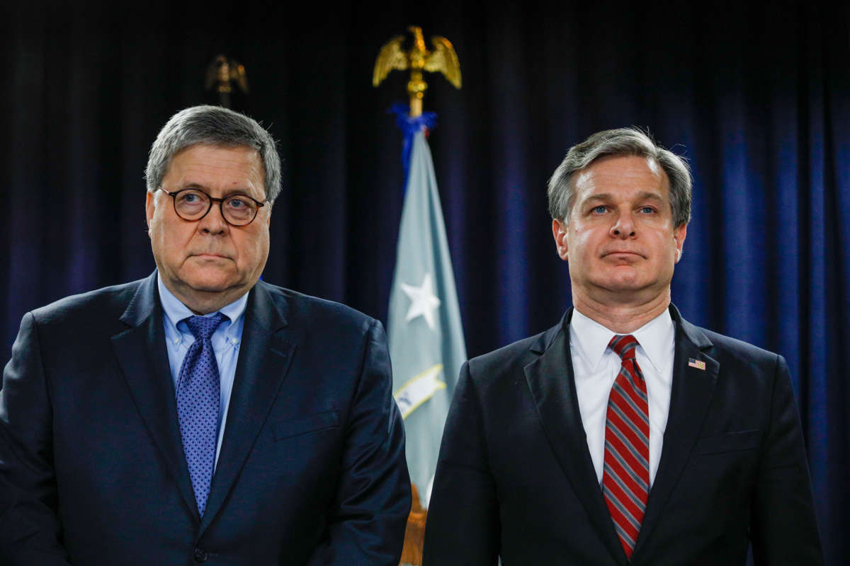 Attorney General William Barr and FBI Director Christopher Wray stand together to announce a crime reduction initiative on December 18, 2019 in Detroit, Michigan.