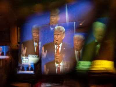 President Trump is seen on screen through a window at a watch party for the final presidential debate with former Vice President Joe Biden on October 22, 2020, in San Antonio, Texas.