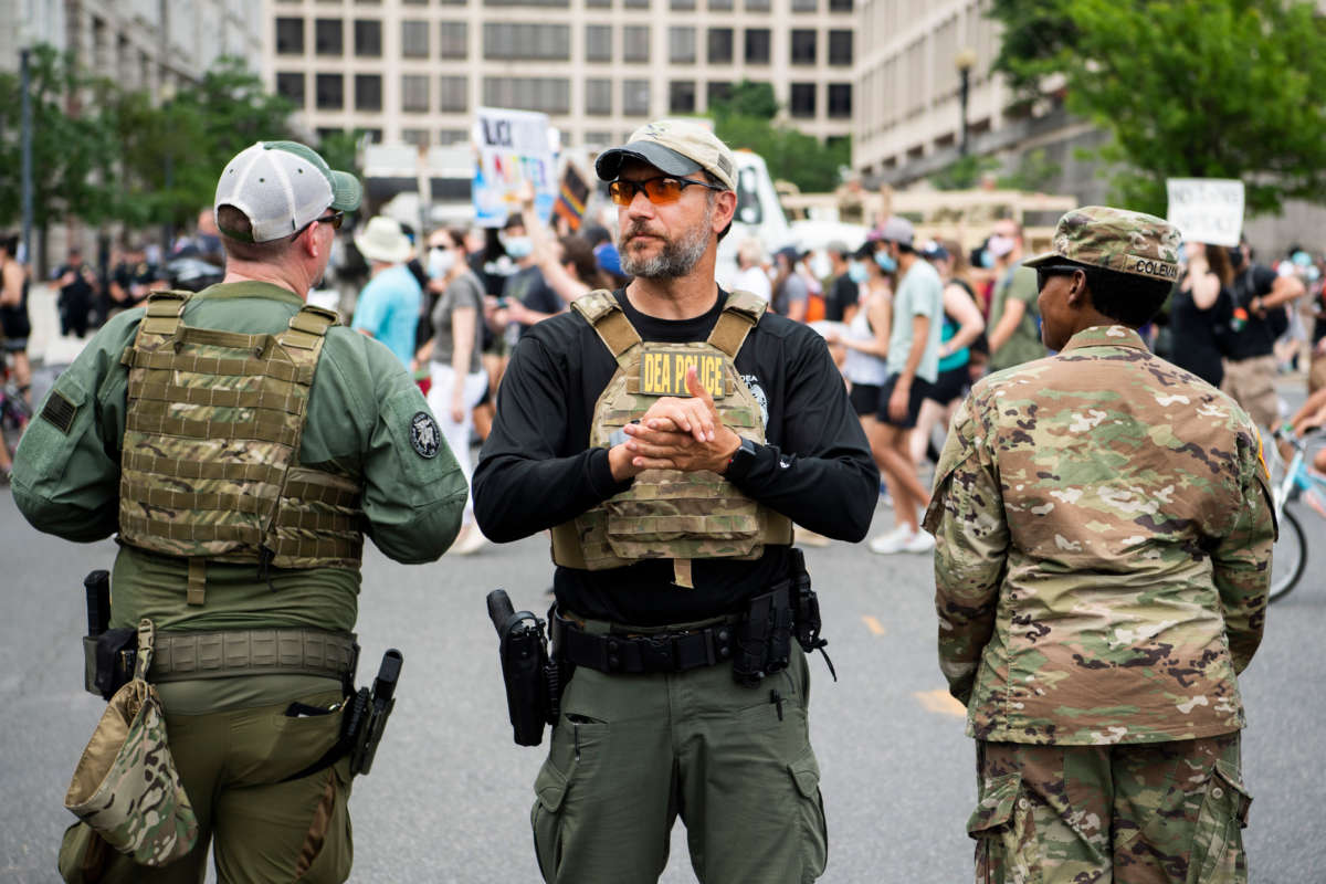 Drug Enforcement Administration police are seen as demonstrators march to Freedom Plaza from Capitol Hill to honor George Floyd and victims of racial injustice on June 6, 2020.