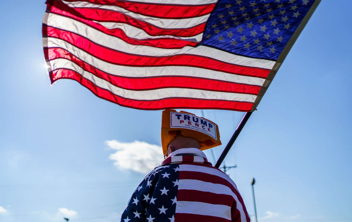 A supporter of President Trump waves a U.S. flag at a rally in West Salem, Wisconsin, on October 27, 2020.