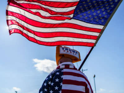 A supporter of President Trump waves a U.S. flag at a rally in West Salem, Wisconsin, on October 27, 2020.