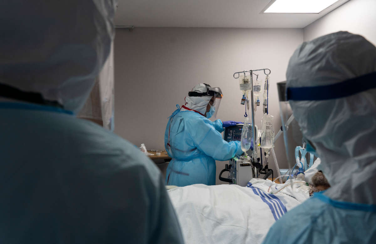 Members of the medical staff treat a patient in the COVID-19 intensive care unit at the United Memorial Medical Center on July 28, 2020, in Houston, Texas.