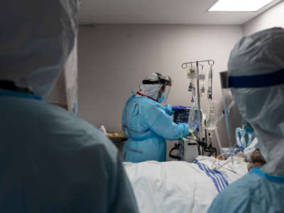 Members of the medical staff treat a patient in the COVID-19 intensive care unit at the United Memorial Medical Center on July 28, 2020, in Houston, Texas.