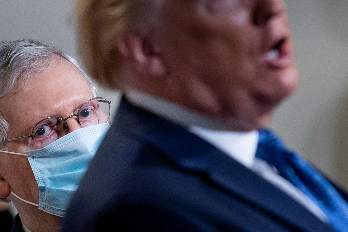 Mitch Mcconnell looks over donald trump's shoulder