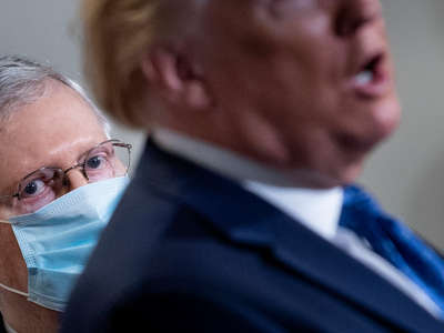 Mitch Mcconnell looks over donald trump's shoulder