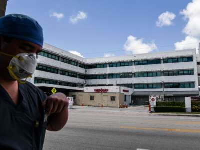 A medic walks outside of a hospital in Coral Gables near Miami, Florida, on July 30, 2020.