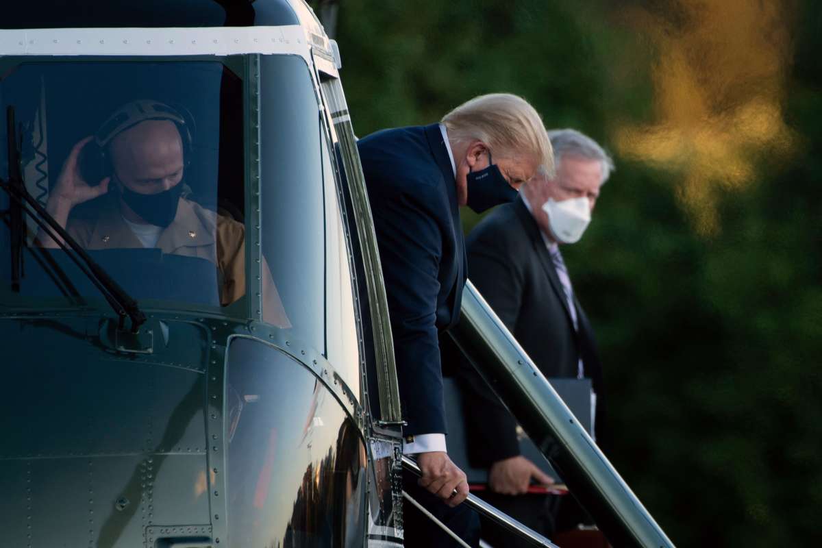 White House Chief of Staff Mark Meadows (right) watches as President Donald Trump walks off Marine One while arriving at Walter Reed Medical Center in Bethesda, Maryland, on October 2, 2020, after testing positive for COVID-19.