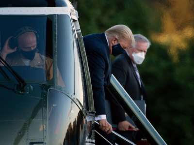 White House Chief of Staff Mark Meadows (right) watches as President Donald Trump walks off Marine One while arriving at Walter Reed Medical Center in Bethesda, Maryland, on October 2, 2020, after testing positive for COVID-19.