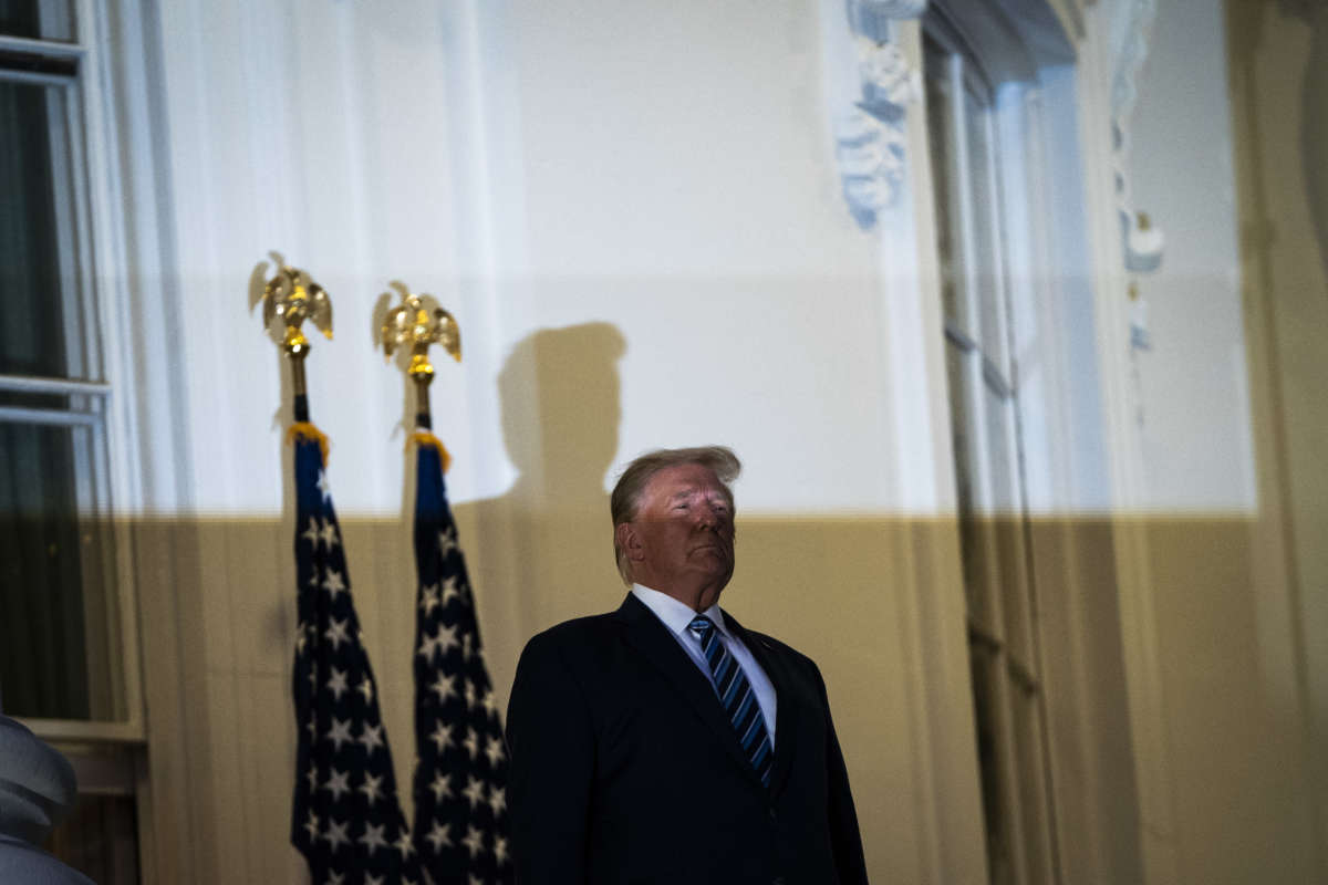 Donald Trump watches Marine One from the Truman Balcony as he returns home after receiving treatments for COVID-19 at Walter Reed National Military Medical Center, at the White House on October 5, 2020, in Washington, D.C.