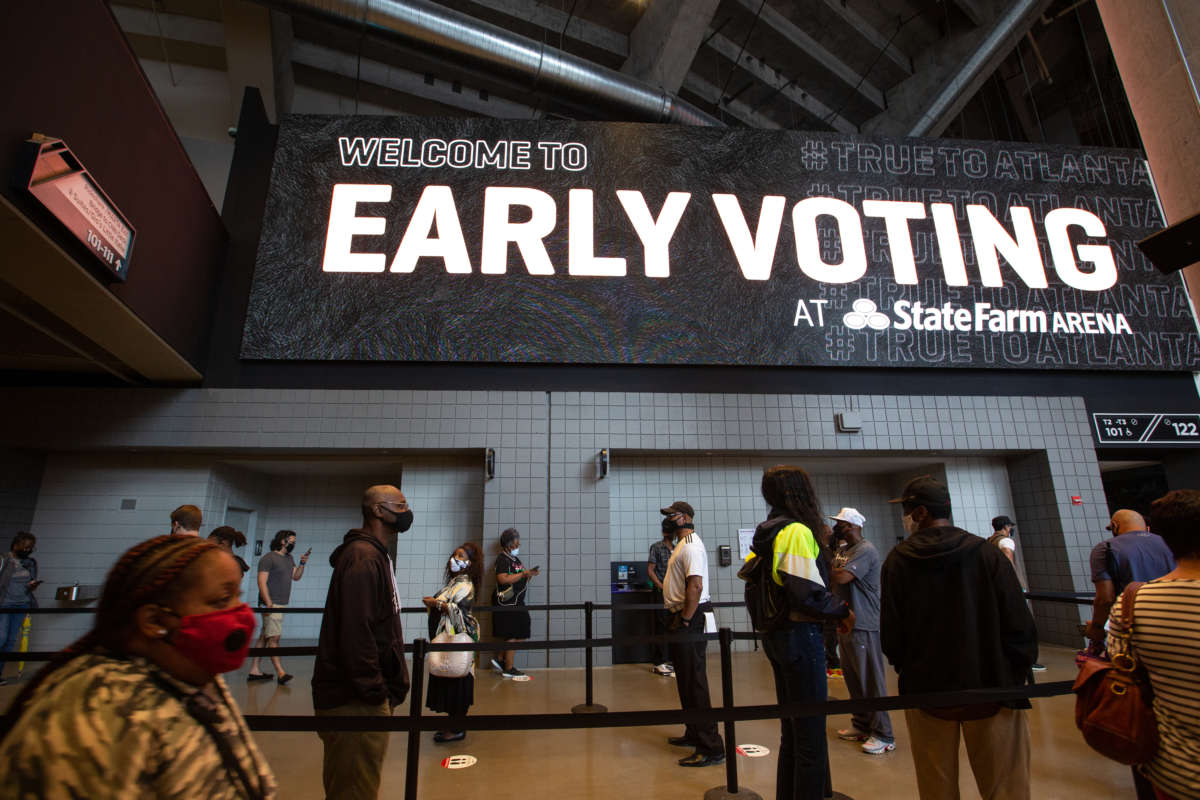 Voters line up inside of State Farm Arena, Georgia's largest early voting location, for the first day of early voting in the general election on October 12, 2020, in Atlanta, Georgia.
