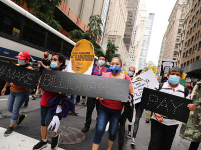 People participate in a "March on Billionaires" event on July 17, 2020, in New York City.