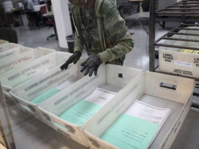 A worker at the Miami-Dade County Elections Department works on tabulating the vote by mail ballots that have been returned for the general election on October 30, 2020, in Doral, Florida.