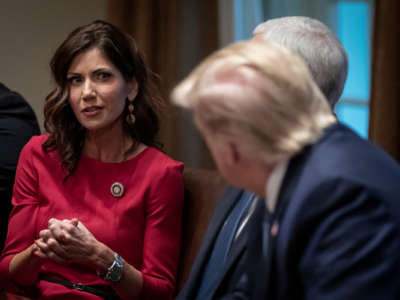 Kristi Noem speaks to Donald Trump