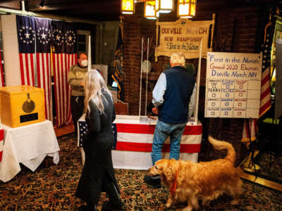 Voters gather at the Hale House at the historic Balsams Resort during midnight voting as part of the first ballots cast in the U.S. presidential election in Dixville Notch, New Hampshire, on November 3, 2020.