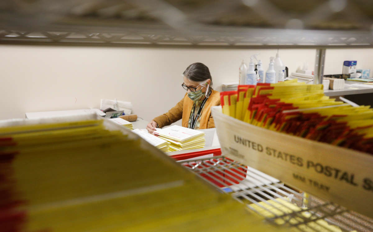 Mail-in ballots sit in containers from the U.S. Postal Service waiting to be processed by election workers at the Salt Lake County election office in Salt Lake City, Utah, on October 29, 2020.