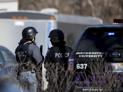 University police talk to eachother by a cop suv