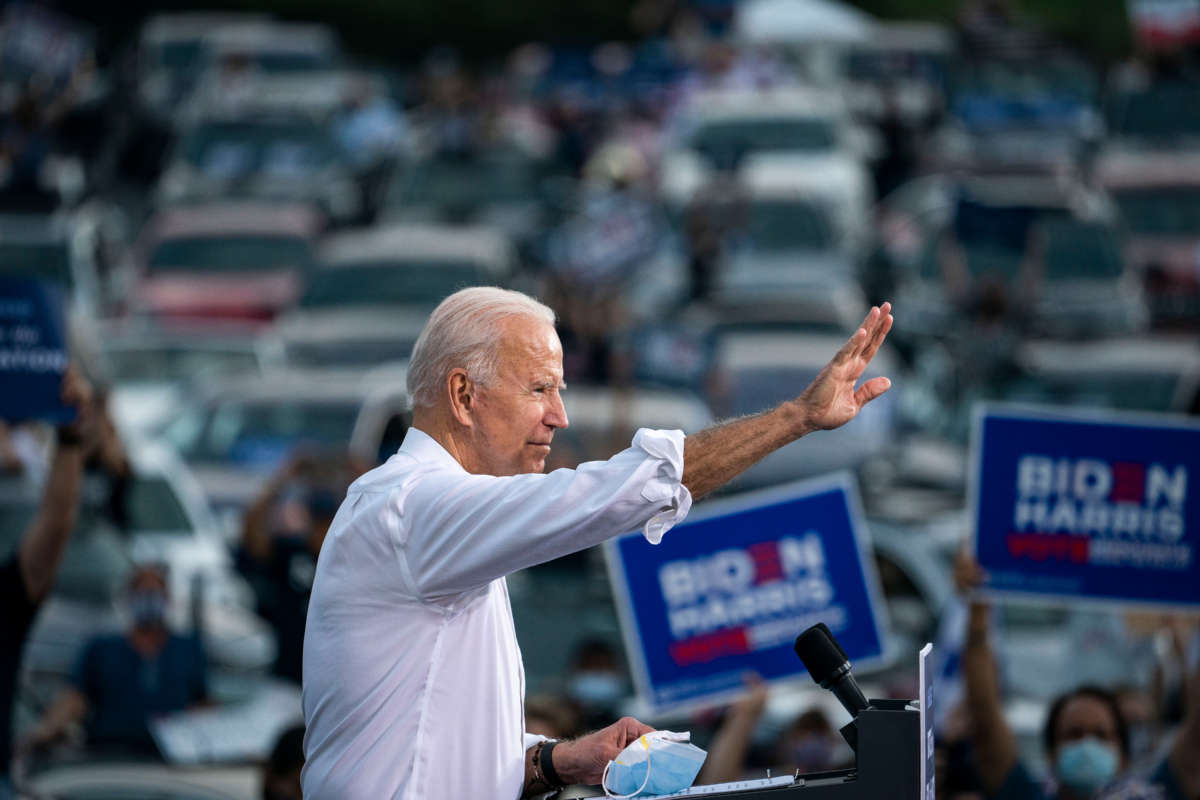 Democratic presidential nominee Joe Biden waves to supporters as he finishes speaking during a drive-in campaign rally in the parking lot of Cellairis Ampitheatre on October 27, 2020, in Atlanta, Georgia.