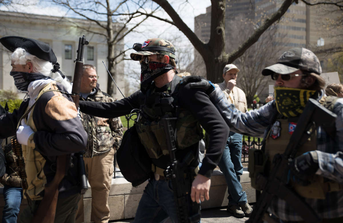 A local militia walks to the Ohio State House in Columbus, Ohio, on April 18, 2020, to protest the state's order to stay home to limit the spread of COVID-19.