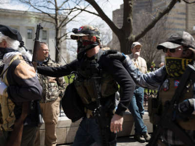 A local militia walks to the Ohio State House in Columbus, Ohio, on April 18, 2020, to protest the state's order to stay home to limit the spread of COVID-19.