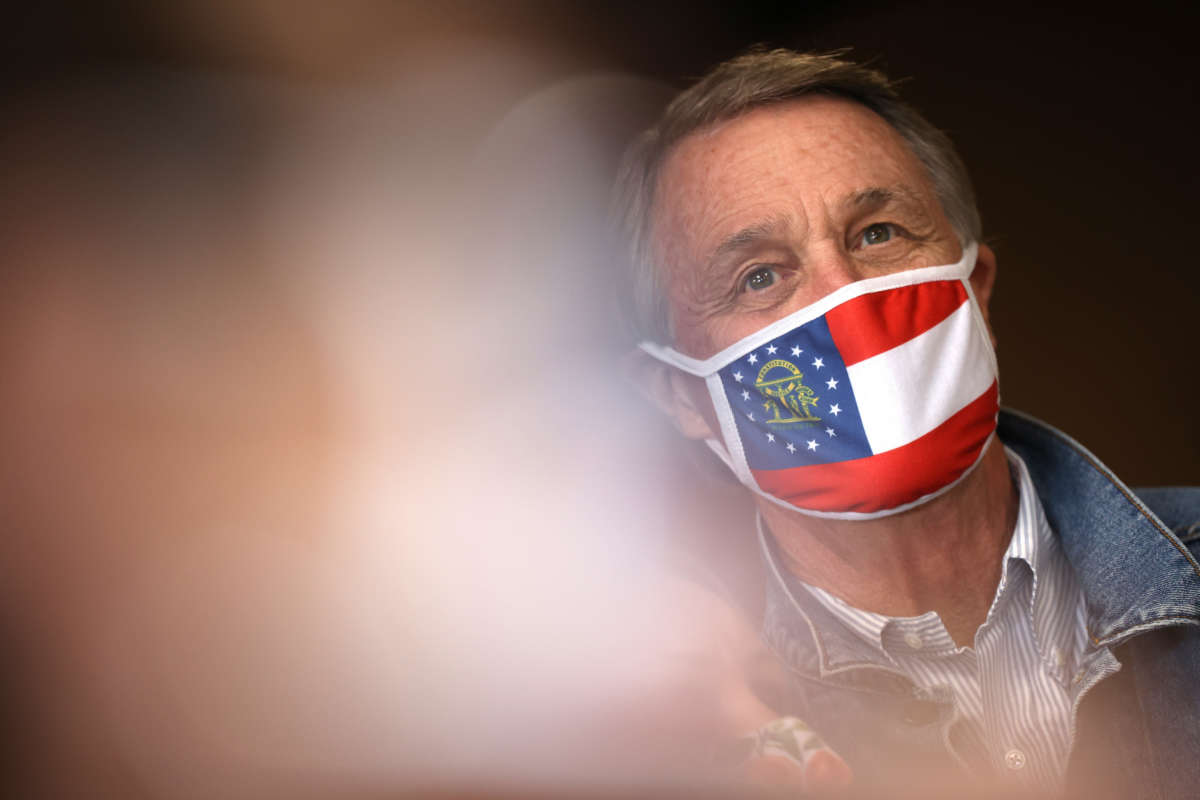 Sen. David Perdue looks on during a campaign event at Pot Luck Cafe on October 31, 2020, in Monroe, Georgia.