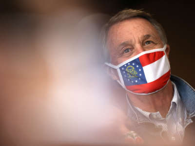 Sen. David Perdue looks on during a campaign event at Pot Luck Cafe on October 31, 2020, in Monroe, Georgia.