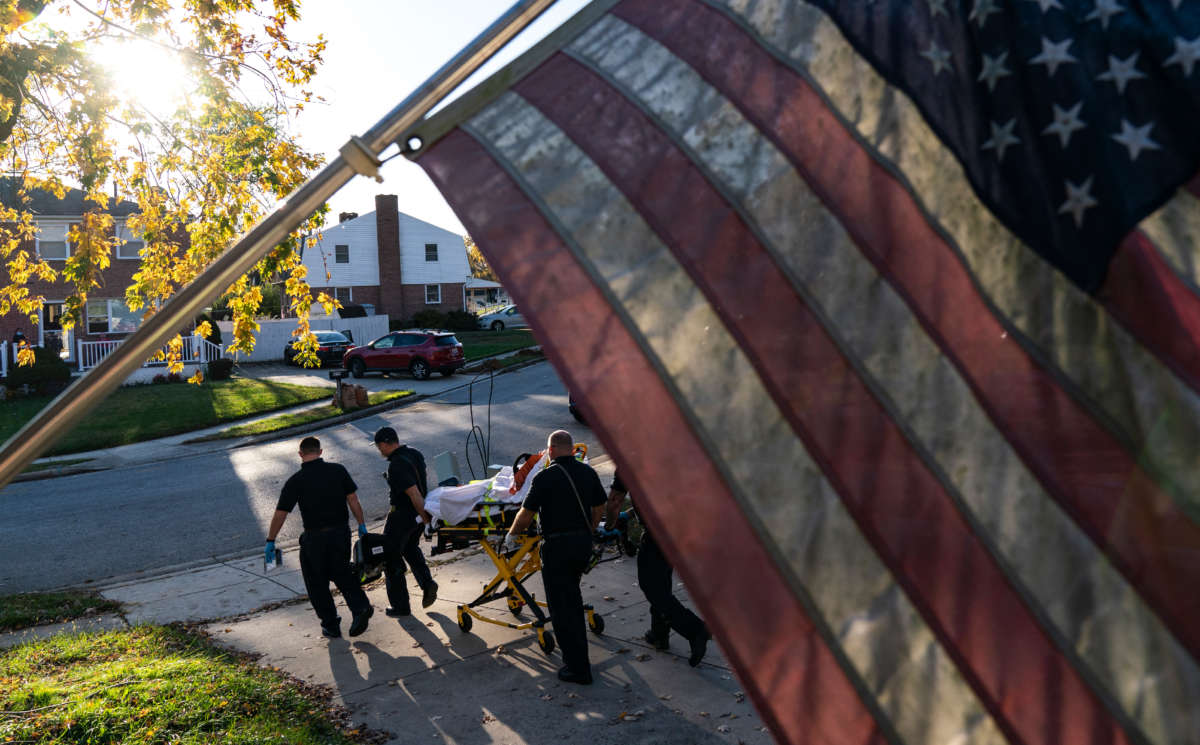 Paramedics and firefighters with Anne Arundel County Fire Department prepare to transport a patient to the hospital on November 10, 2020, in Glen Burnie, Maryland.