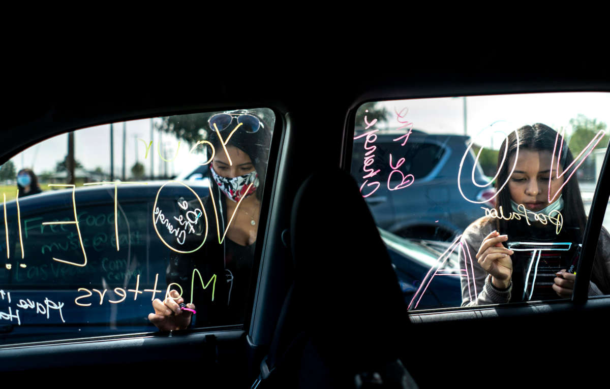 Organized by Mi Familia Vota, Latinx women decorate their cars with a "get out the vote" theme in preparation for a car parade on route to an early voting location in Las Vegas, Nevada, on October 24, 2020.