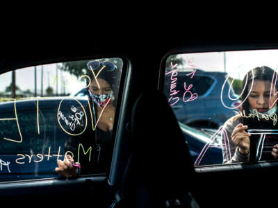 Organized by Mi Familia Vota, Latinx women decorate their cars with a "get out the vote" theme in preparation for a car parade on route to an early voting location in Las Vegas, Nevada, on October 24, 2020.