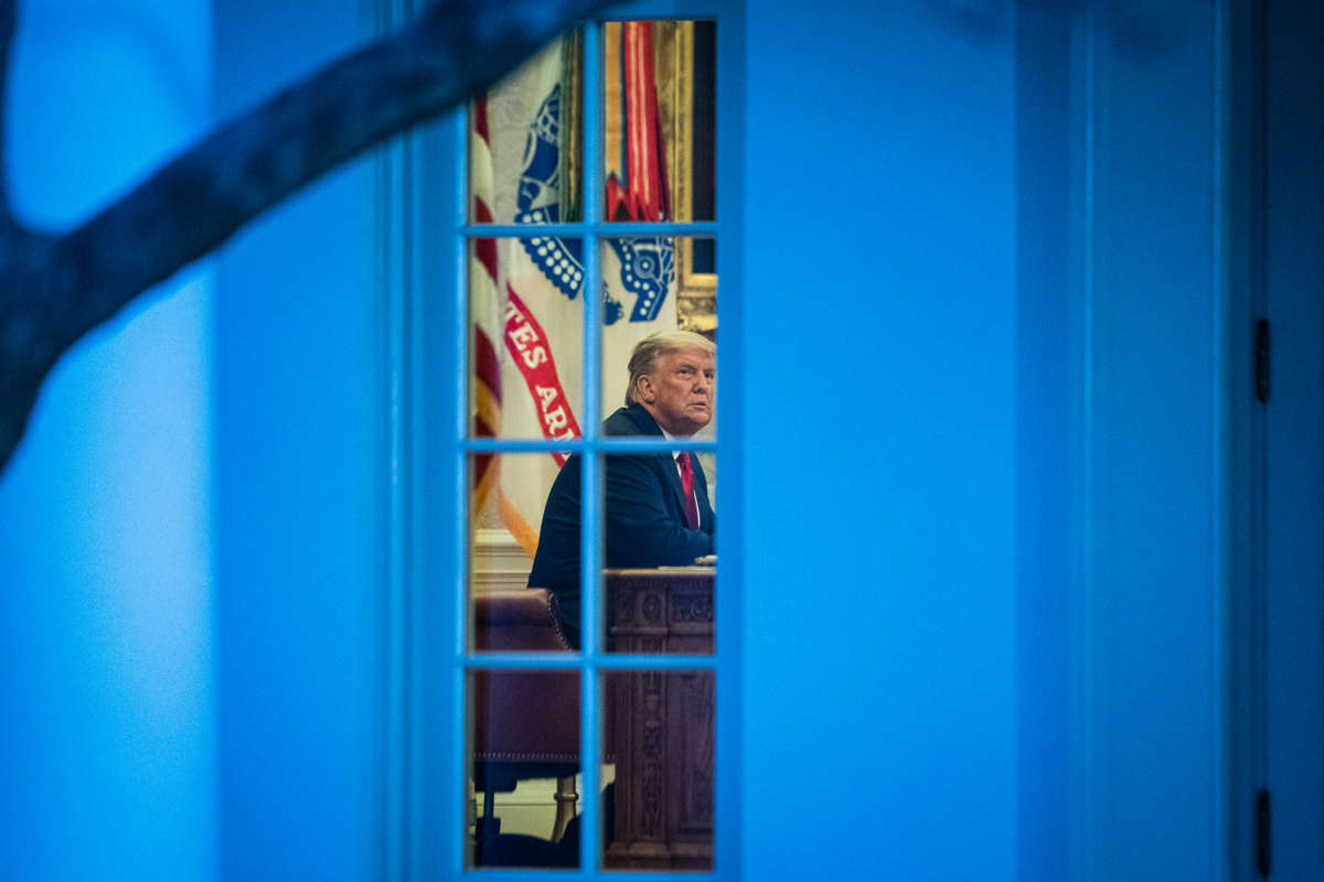 Donald Trump is seen through the windows of the white house