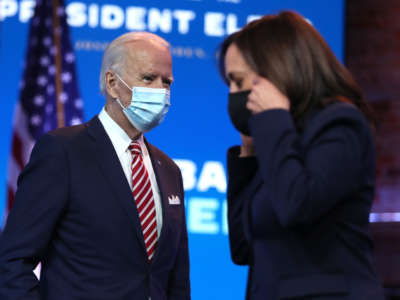 President-elect Joe Biden walks by Vice President-elect Kamala Harris as he prepares to deliver remarks about the U.S. economy during a press briefing at the Queen Theater on November 16, 2020, in Wilmington, Delaware.