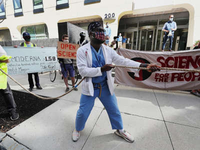 Protesters advocating for price controls on COVID-19 vaccines outside Moderna Therapeutics headquarters