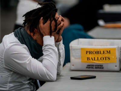 A Board of elections worker takes a quick break after processing ballots at the Detroit Department of Elections Central Counting Board of Voting absentee ballot counting center at TCF Center on November 4, 2020, in Detroit, Michigan.