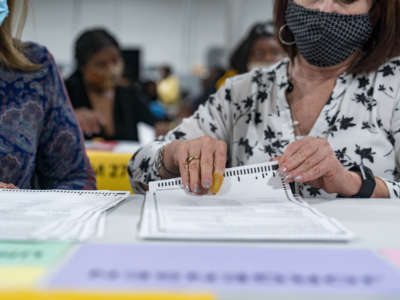 Gwinnett county workers begin their recount of the ballots on November 13, 2020, in Lawrenceville, Georgia.