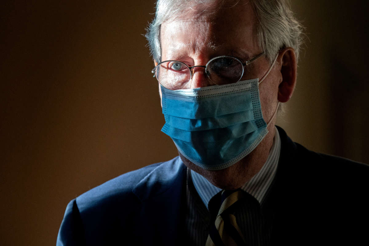 Senate Majority Leader Mitch McConnell wears a protective mask as he walks to his office following a roll call vote at the U.S. Capitol on September 21, 2020, in Washington, D.C.