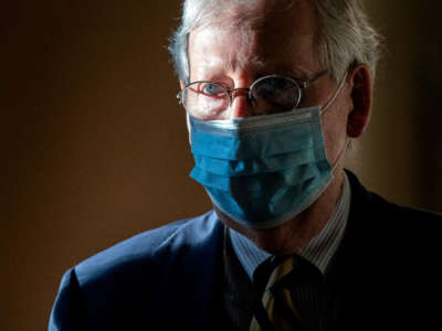 Senate Majority Leader Mitch McConnell wears a protective mask as he walks to his office following a roll call vote at the U.S. Capitol on September 21, 2020, in Washington, D.C.