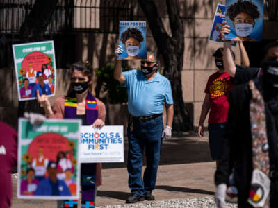 Clergy with signs hold a rally calling for congress to pass feral relief outside of the Ronald Regan State Building on May 15, 2020, in Los Angeles, California.