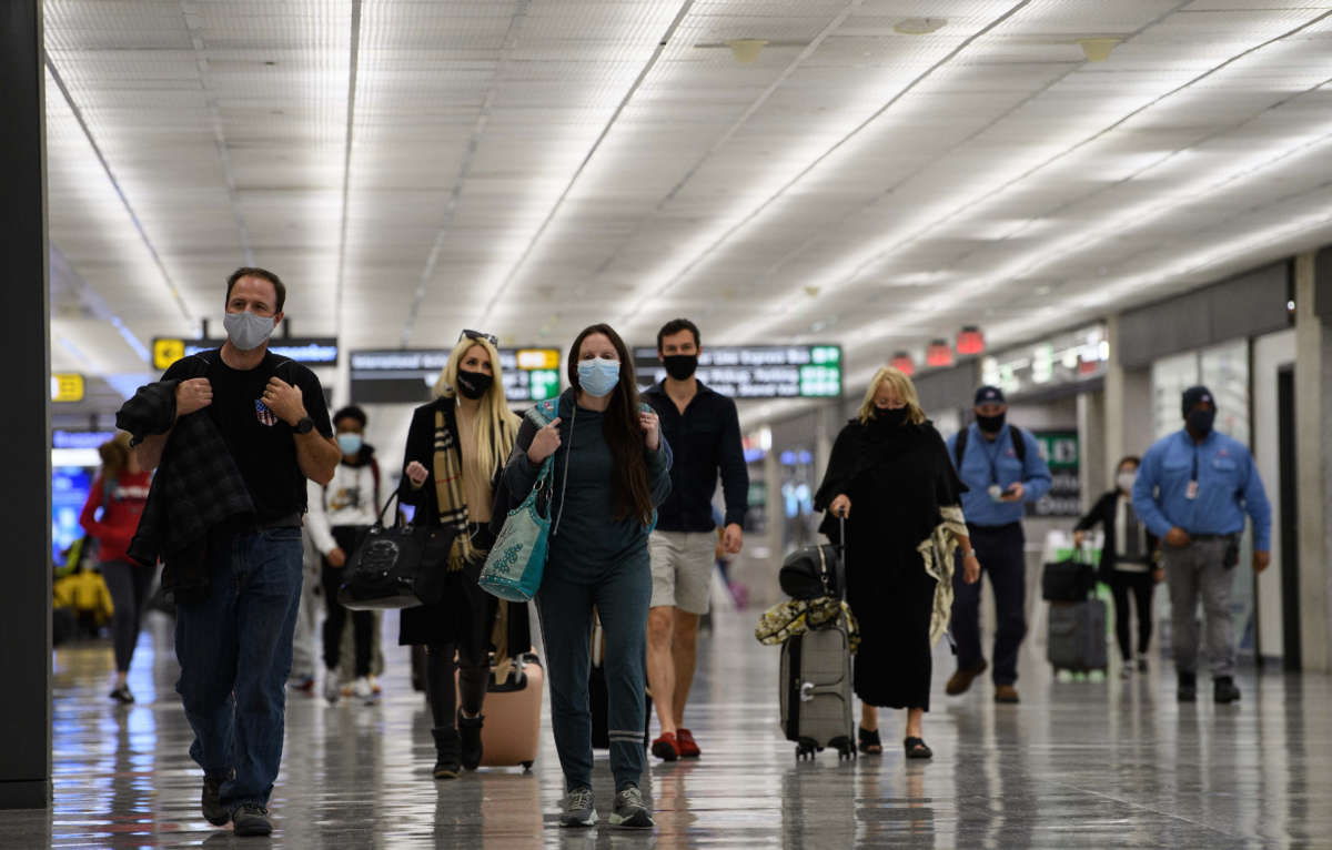 Travelers walk through Washington Dulles International Airport in Dulles, Virginia, on November 24, 2020.
