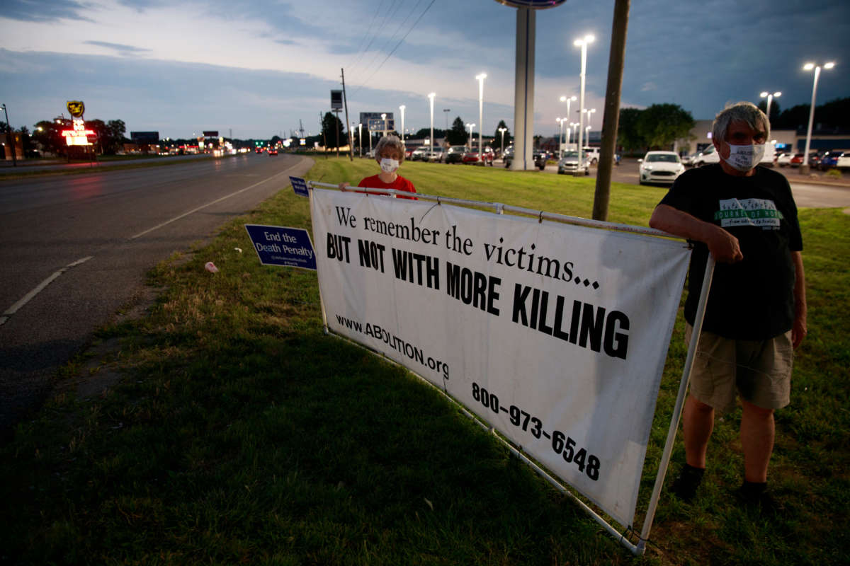 Protesters stand near an intersection on July 15, 2020, not far from the Terre Haute Federal Correctional Complex, where death row inmate Wesley Ira Purkey was scheduled to be executed by lethal injection.