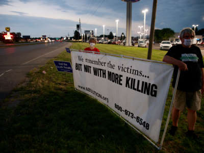 Protesters stand near an intersection on July 15, 2020, not far from the Terre Haute Federal Correctional Complex, where death row inmate Wesley Ira Purkey was scheduled to be executed by lethal injection.