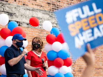 Democratic Senate candidate Mark Kelly and former Arizona congresswoman Gabrielle Giffords speak to supporters and volunteers during a Phoenix Early Vote Event near a downtown early voting site on October 24, 2020, in Phoenix, Arizona.