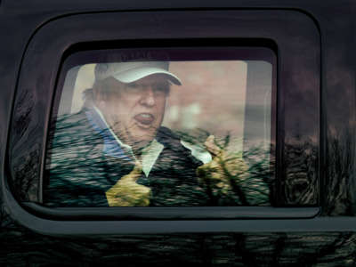 President Trump gives thumbs up to supporters from his motorcade after golfing at Trump National Golf Club on November 22, 2020, in Sterling, Virginia.