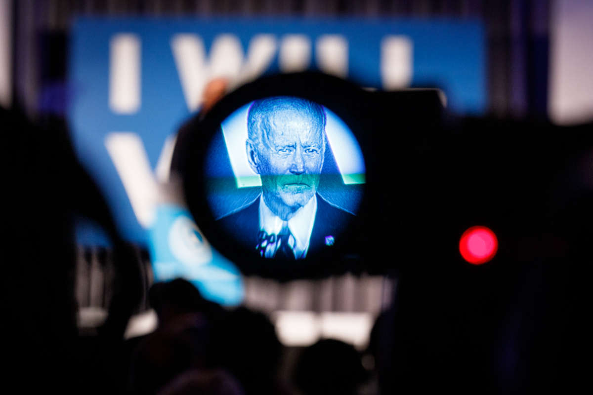 Joe Biden is seen through the viewfinder of a camera