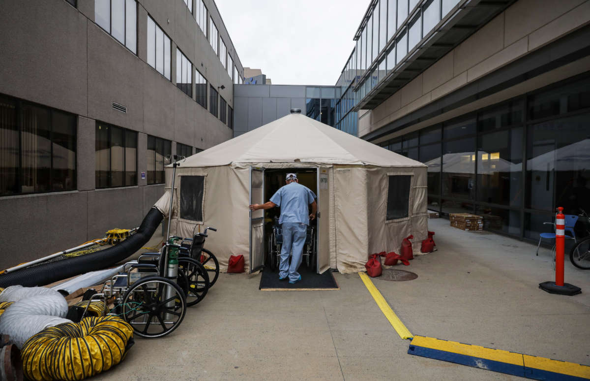 A PCA rolls a patient out of a temporary tent set up at UMass Memorial Hospital in Worcester, Massachussetts, on November 11, 2020.