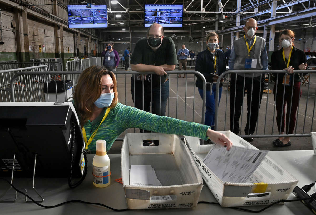 A return board member files a ballot after it was double checked at the Allegheny County Elections Warehouse in Pittsburgh, Pennsylvania, on November 6, 2020.