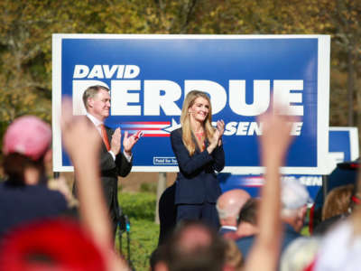 Sen. David Perdue and Sen. Kelly Loeffler listen to Vice President Mike Pence deliver remarks at a Defend the Majority Rally in Canton, Georgia, in support of their campaigns on November 20, 2020.