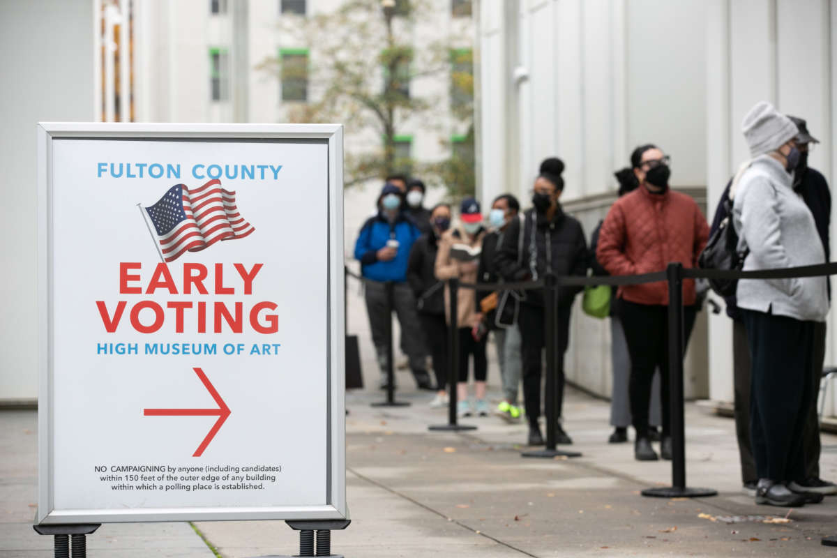 Voters line up for the first day of early voting outside of the High Museum polling station on December 14, 2020 in Atlanta, Georgia.