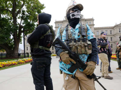 A group tied to the Boogaloo Bois holds a rally as they carry firearms at the Michigan State Capitol in Lansing, Michigan, on October 17, 2020.