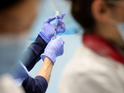 Technicians measure doses of the Pfizer vaccine for COVID-19 at the Virginia Hospital Center on December 16, 2020, in Arlington, Virginia.