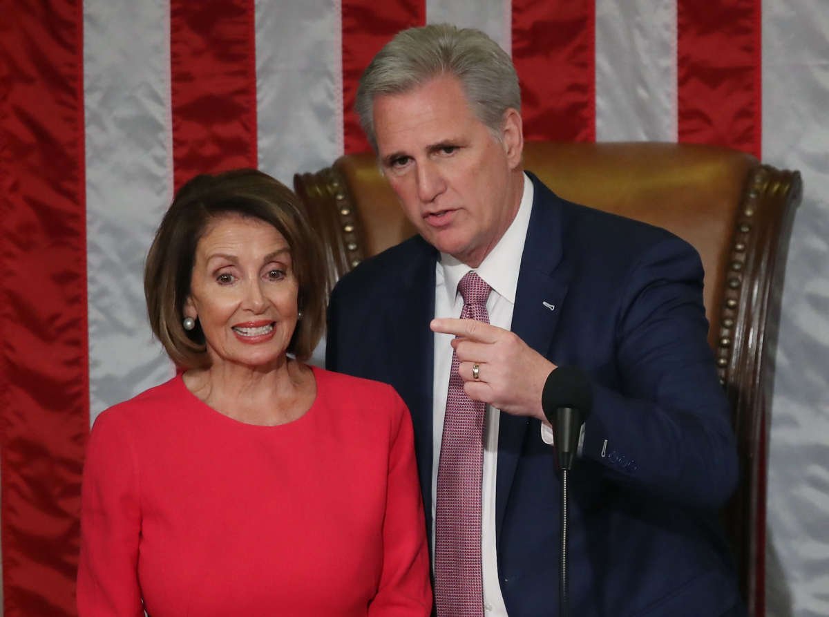 House Minority Leader Kevin McCarthy stands with Speaker of the House designate Nancy Pelosi before she is sworn in sworn in during the first session of the 116th Congress at the U.S. Capitol on January 3, 2019, in Washington, D.C.