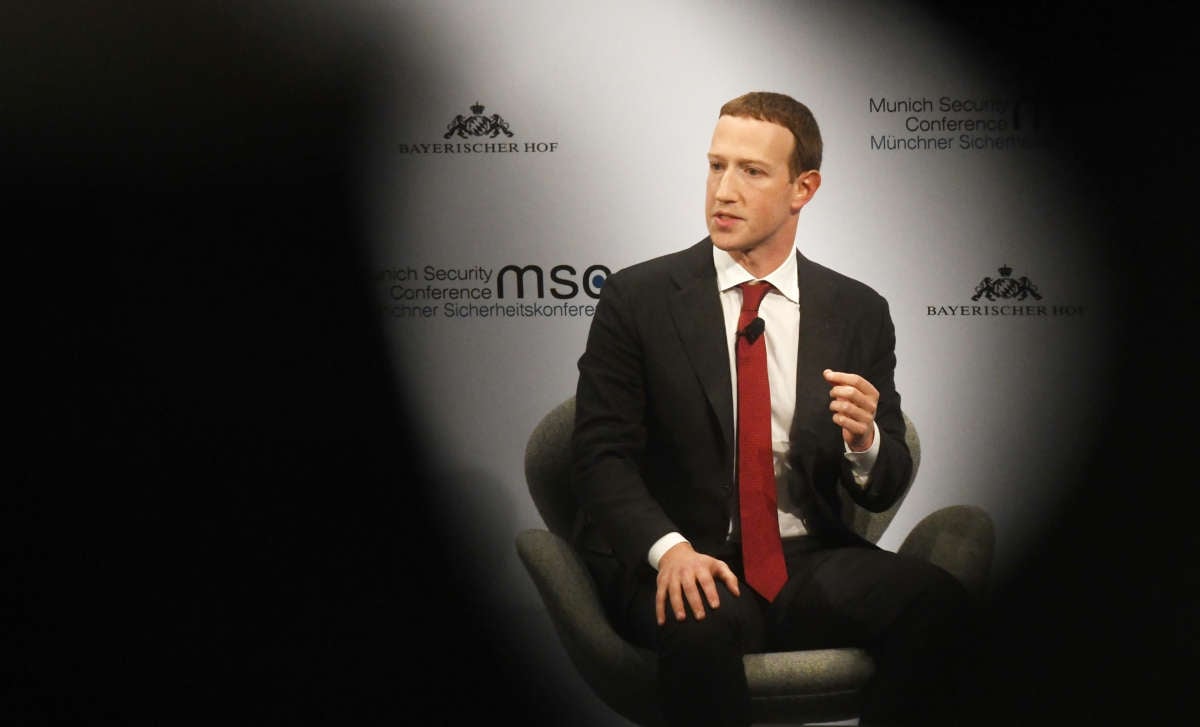 Mark Zuckerberg participates in a panel interview with spooky shadows in the foreground